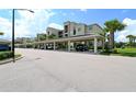 Covered parking for condominium with multiple parking spaces and mature landscaping at 17704 Gawthrop Dr # 303, Lakewood Ranch, FL 34211