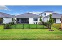 Spacious fenced backyard with lush green grass, ready for outdoor enjoyment at 18510 Midsummer Pl, Venice, FL 34293