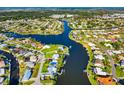 Expansive aerial showcases the community's canal-front homes, blending waterfront living with lush landscapes at 1921 Fairview Dr, Englewood, FL 34223