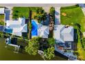 This aerial view highlights the home's private pool, waterfront access, and dock for serene coastal living at 1921 Fairview Dr, Englewood, FL 34223