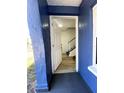 Inviting entryway with open door, showcasing wood-look flooring and the staircase at 1947 Los Lomas Dr, Clearwater, FL 33763