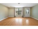 Bright living room featuring hardwood floors, a large window, and fresh paint at 2015 Bayshore Gardens Pkwy, Bradenton, FL 34207