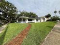 Charming one-story home featuring a brick walkway and lush, green lawn at 2333 22Nd S St, St Petersburg, FL 33712