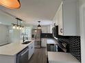 Bright kitchen with island, stainless appliances, black hardware, and modern backsplash at 2333 22Nd S St, St Petersburg, FL 33712