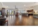 Expansive open-concept living area with wood-look tile floors, lots of natural light, and bar seating at 2350 Virgil Hall Rd, Lithia, FL 33547