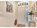 Bright entryway featuring neutral paint, tile flooring, and decorative niches above the door at 24512 Bramhope Ct, Punta Gorda, FL 33980