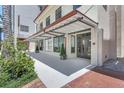 Charming building exterior featuring an awning, inviting storefront, and landscaped surroundings at 33 S Palm Ave # 1101, Sarasota, FL 34236