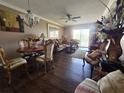 Cozy living and dining area features hardwood floors, slider to the balcony and ceiling fan at 3917 Lake Bayshore Dr # F-307, Bradenton, FL 34205