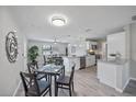 Bright, open-concept kitchen featuring stainless steel appliances, granite countertops, and a dining area at 400 E Baffin Dr, Venice, FL 34293