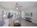 Inviting living room featuring hardwood floors, a ceiling fan, and an open layout to the dining area at 400 E Baffin Dr, Venice, FL 34293