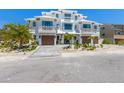 Beautiful modern three-story townhouse with a paver driveway and tropical landscaping at 401 39Th St, Holmes Beach, FL 34217