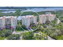 An aerial view of a condo complex showcasing the building's architecture, landscaping, and scenic waterfront location at 401 N Point Rd # 504, Osprey, FL 34229