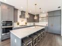 Kitchen with a center island, gray cabinets, and stainless steel appliances at 421 Alamanda Rd, Anna Maria, FL 34216
