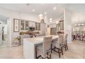 Bright kitchen with pendant lighting, a large island, stainless steel appliances and eat-in counter seating at 4374 Indian Point Trl, Sarasota, FL 34238