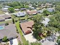 Aerial view of a single-Gathering home featuring a brown roof, attached garage, and a lush backyard at 4637 31St E Ct, Bradenton, FL 34203