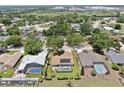 Aerial view of a property showing a pool and outdoor living area in a neighborhood with mature trees at 4637 31St E Ct, Bradenton, FL 34203
