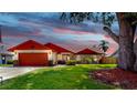 Charming single-story home with a well-manicured lawn, two-car garage, and colorful front-door accent at 4637 31St E Ct, Bradenton, FL 34203
