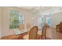 Bright dining area with high ceilings, large windows, and a stylish glass-top table with seating at 5044 Creekside Trl, Sarasota, FL 34243