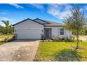 Charming single-story home with a well-maintained lawn, brick driveway, and a two-car garage at 5213 Patano Loop, Palmetto, FL 34221
