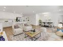 Open-concept living space with modern furnishings, including a dining area and white kitchen at 5213 Patano Loop, Palmetto, FL 34221