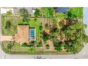 Overhead view showcasing a home with a private pool, fenced backyard, and mature landscaping at 5307 Kenvil Dr, North Port, FL 34288