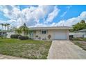 Charming single-story home with a well-maintained lawn, mature landscaping, and attached one car garage at 5412 Skyline Pl, Sarasota, FL 34232