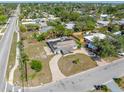 Aerial view of a single story home showing roof damage, surrounding neighborhood and nearby roadways at 5705 23Rd W St, Bradenton, FL 34207