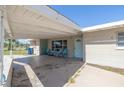 A very large carport with an entrance door and with chairs on the front porch at 5705 23Rd W St, Bradenton, FL 34207
