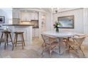 Cozy dining area with seating for four, built-in bar area, and stylish decor at 5880 Midnight Pass Rd # 207, Sarasota, FL 34242