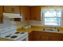 Cozy kitchen featuring bright countertops, and white appliances at 6300 Flotilla Dr # 108, Holmes Beach, FL 34217
