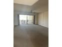 Open living room with sliding glass doors to balcony and neutral carpet at 6300 Flotilla Dr # 108, Holmes Beach, FL 34217