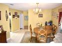Traditional dining room with wood table, six chairs, chandelier, and decorative accents creating a cozy atmosphere at 6704 Rosemary Dr, Tampa, FL 33625
