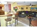 Open floor plan connecting the kitchen and living room, offering a seamless flow for entertaining and relaxation at 6704 Rosemary Dr, Tampa, FL 33625