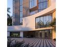 Stylish condo entrance featuring modern architecture, sleek design elements and a luxury vehicle at 688 Golden Gate Point # 201, Sarasota, FL 34236