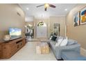 Bright living room with tile floors, comfortable seating, and a view of the entryway at 7321 Hemlock Ln, Sarasota, FL 34241