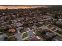Aerial view of a residential neighborhood with a lake in the background; property highlighted in white at 7404 13Th Avenue W Dr, Bradenton, FL 34209