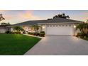 Beautifully landscaped single-story home with a well-maintained lawn and a two-car garage at 7404 13Th Avenue W Dr, Bradenton, FL 34209