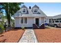 Charming two-story home with a gray exterior, landscaped yard, and a stone walkway at 766 13Th S Ave, St Petersburg, FL 33701