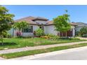 A charming single-story home with landscaped yard, a tile roof, and an attached garage at 8020 Clearwater Ct, Sarasota, FL 34241