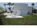Relaxing patio area featuring a white outdoor table and chairs, perfect for entertaining or enjoying the outdoors at 845 S Green Cir, Venice, FL 34285