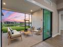 Relaxing screened patio offering comfortable seating and views of the tranquil pond at 8962 Baroque Ter, Sarasota, FL 34240