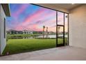 Beautiful backyard view of a well maintained lawn that meets a lake at 8962 Baroque Ter, Sarasota, FL 34240