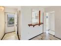 Welcoming entryway with marble tile flooring, a utility window, and convenient access to the kitchen at 9200 Midnight Pass Rd # 30, Sarasota, FL 34242