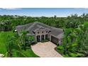 Stunning exterior view showcasing landscaping, driveway, and beautiful architectural details at 932 Mangrove Edge Ct, Bradenton, FL 34208