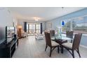 Bright living room with modern tile floors, comfortable seating, and a view of the balcony at 110 Vista Hermosa Cir # 302B, Sarasota, FL 34242