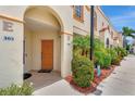 Exterior view of condo front door with colorful landscaping and decor at 1216 Rio De Janeiro Ave # 306, Punta Gorda, FL 33983
