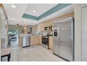 Bright kitchen with stainless steel appliances, light wood cabinets, and tiled floor at 1216 Rio De Janeiro Ave # 306, Punta Gorda, FL 33983