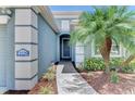 Close-up of the home's exterior, highlighting the address, arched doorway, and neat landscaping at 12229 Stuart Dr, Venice, FL 34293