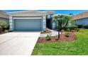Inviting home with a two-car garage, complemented by verdant landscaping and a winding walkway at 12229 Stuart Dr, Venice, FL 34293