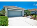 A well kept home featuring a large garage and wide driveway offering ample parking at 12229 Stuart Dr, Venice, FL 34293